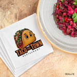 Taco the Town Restaurant logo on a white napkin next to a beet salad.