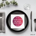 Square napkin with gradient logo on a plate setting.