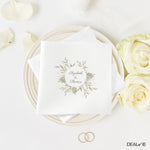 Wedding napkin with floral design and "Elizabeth & Thomas" text.
