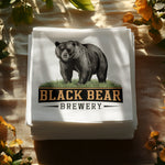 Black Bear Brewery logo on a stack of white napkins.
